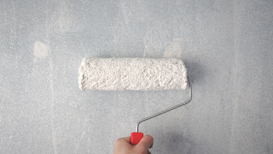 Painting a wall with a roller