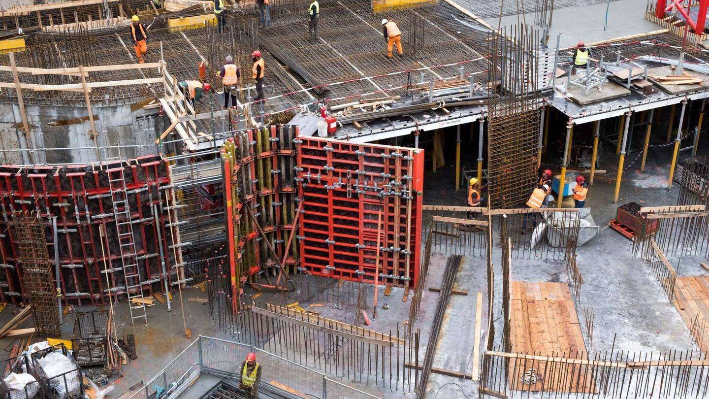 Building construction site with formwork and workers